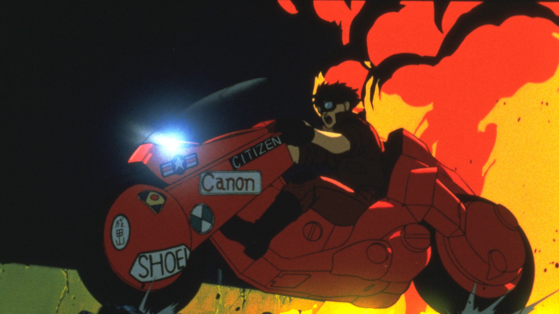 Kaneda riding a motorcycle through Neo-Tokyo in Akira