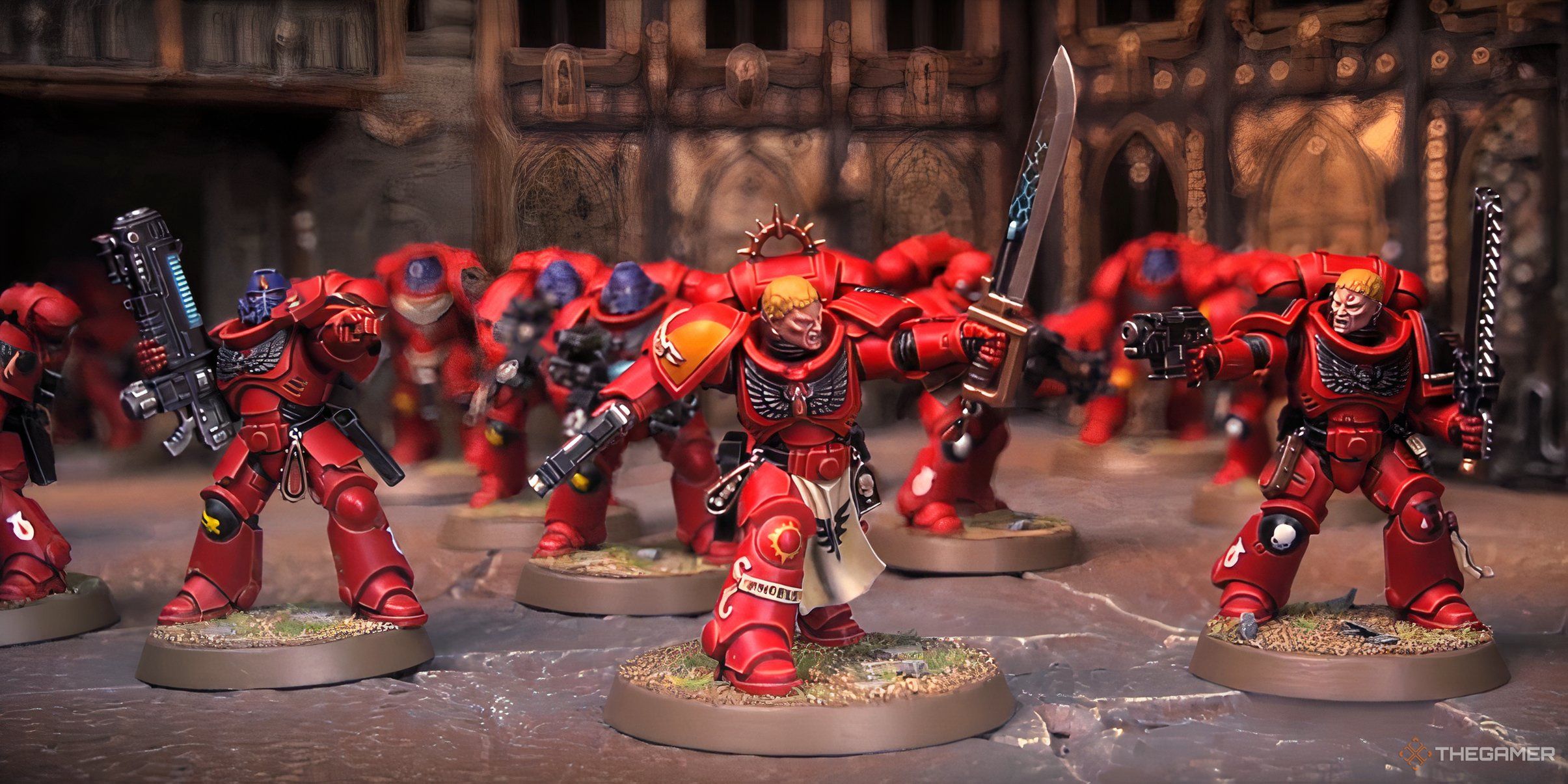 A Blood Angels Captain leading a unit of Intercessors from Warhammer 40,000 tabletop.