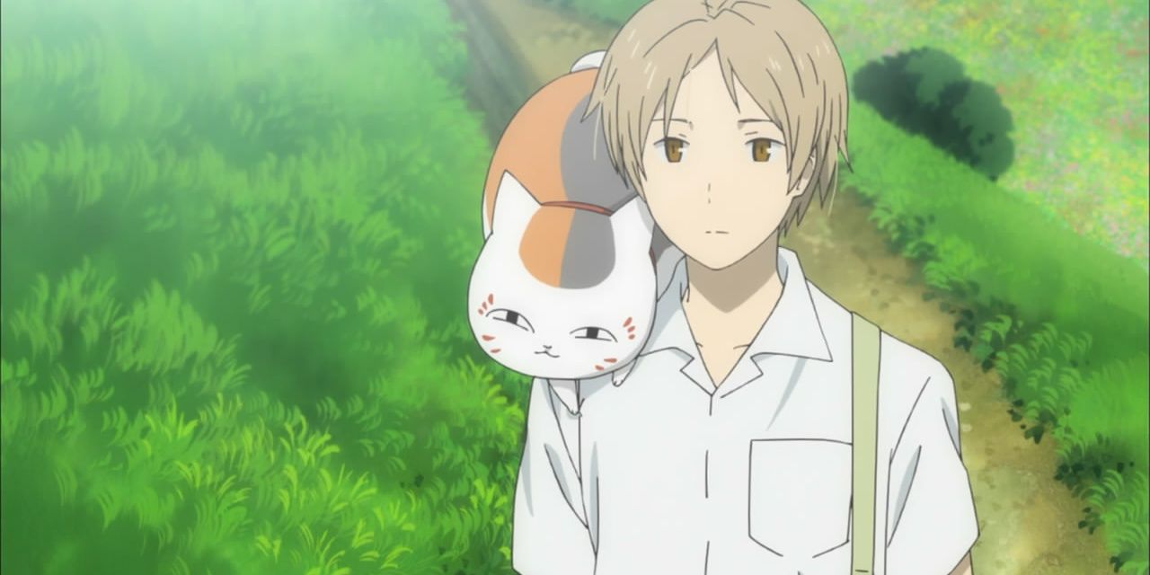 A boy in a white shirt with a cat on his shirt in Natsume’s Book of Friends