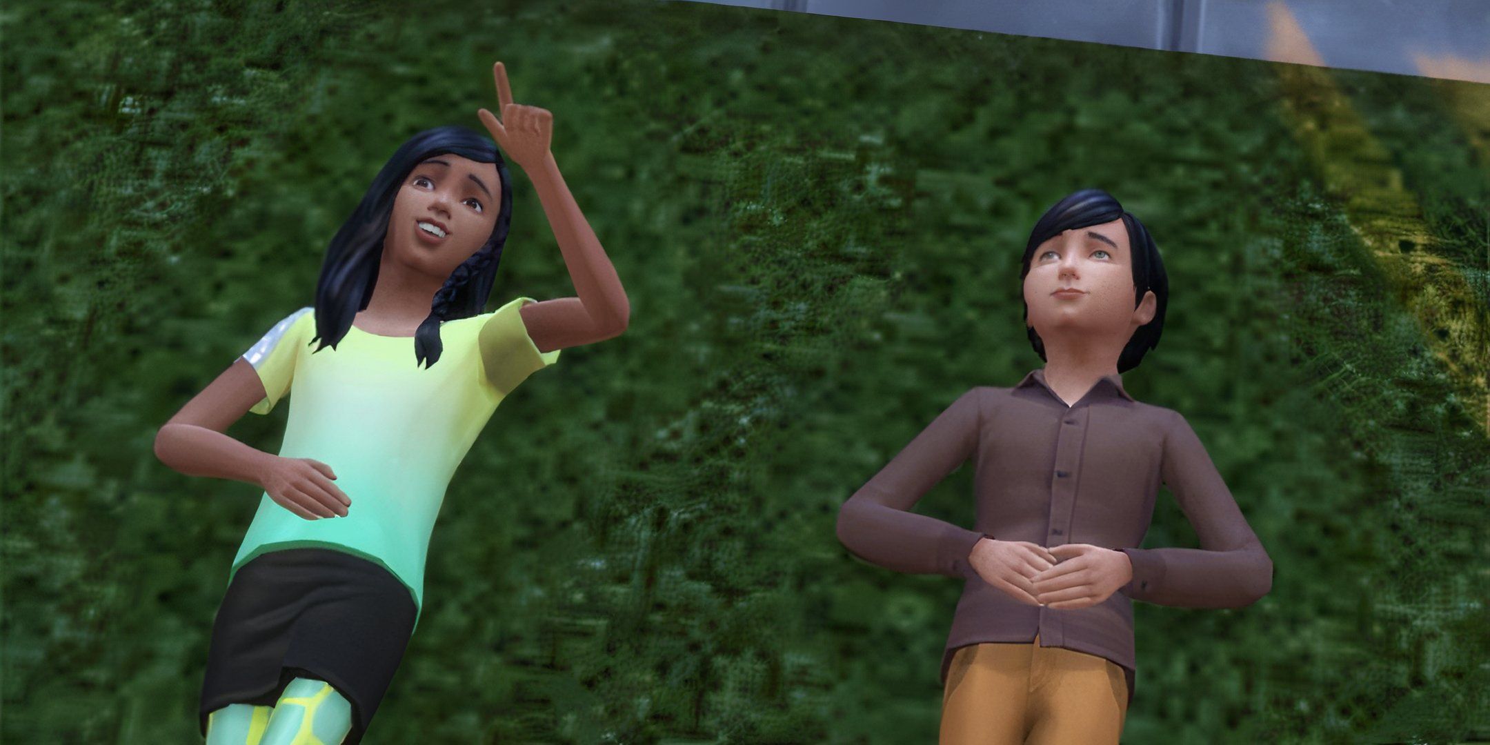 Two child sims laying in the grass.