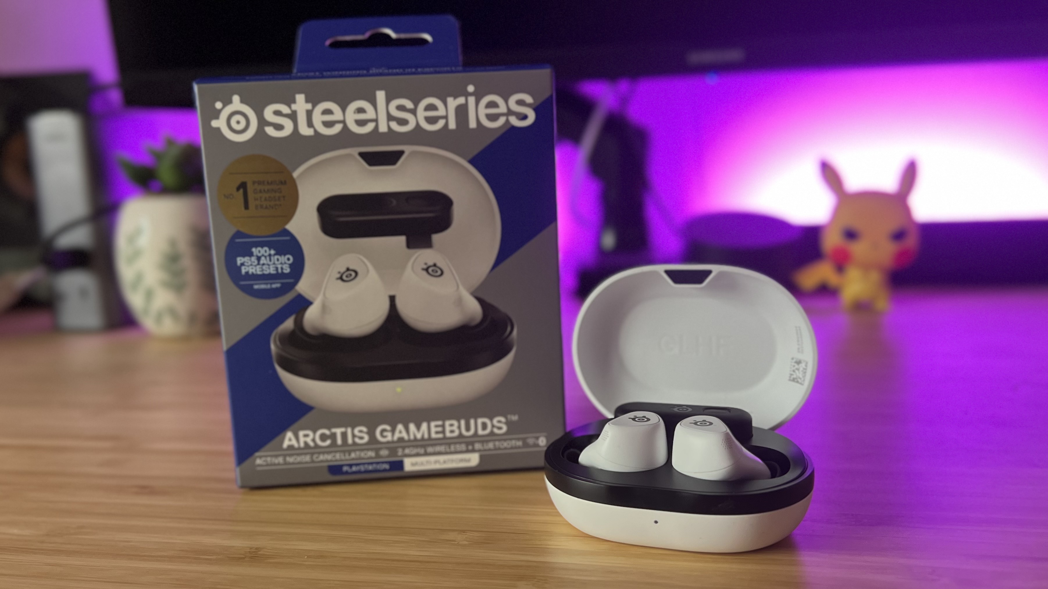 SteelSeries Arctis GameBuds with packaging on a wooden desk