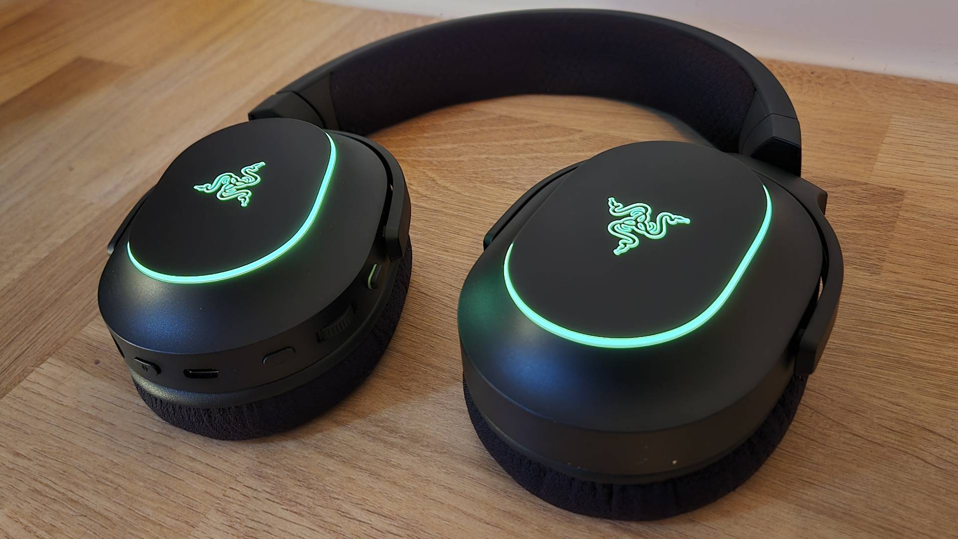 Image of the Razer Barracuda X Chroma gaming headset on a wooden countertop taken by author Rosalie Newcombe.