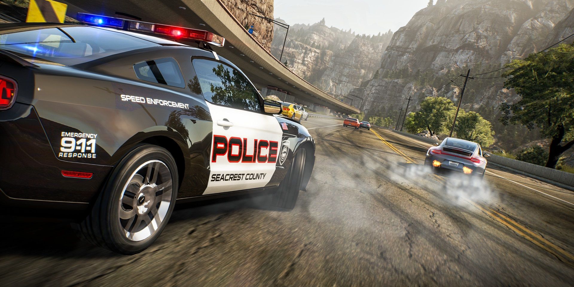 Screenshot of Need For Speed: Hot Pursuit Remastered, showing a police car chasing after a street racer.