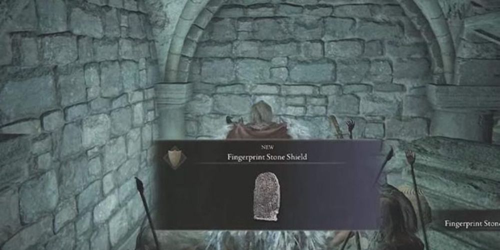 Player looting the Fingerprint Stone Shield in Elden Ring. 