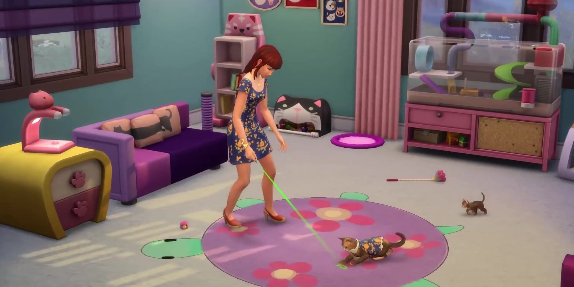 A Sim plays with her cat while kittens run around the brightly-colored purple and blue room.