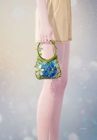 Nikki holding a mini grass bag with a blue gem inside in Infinity Nikki