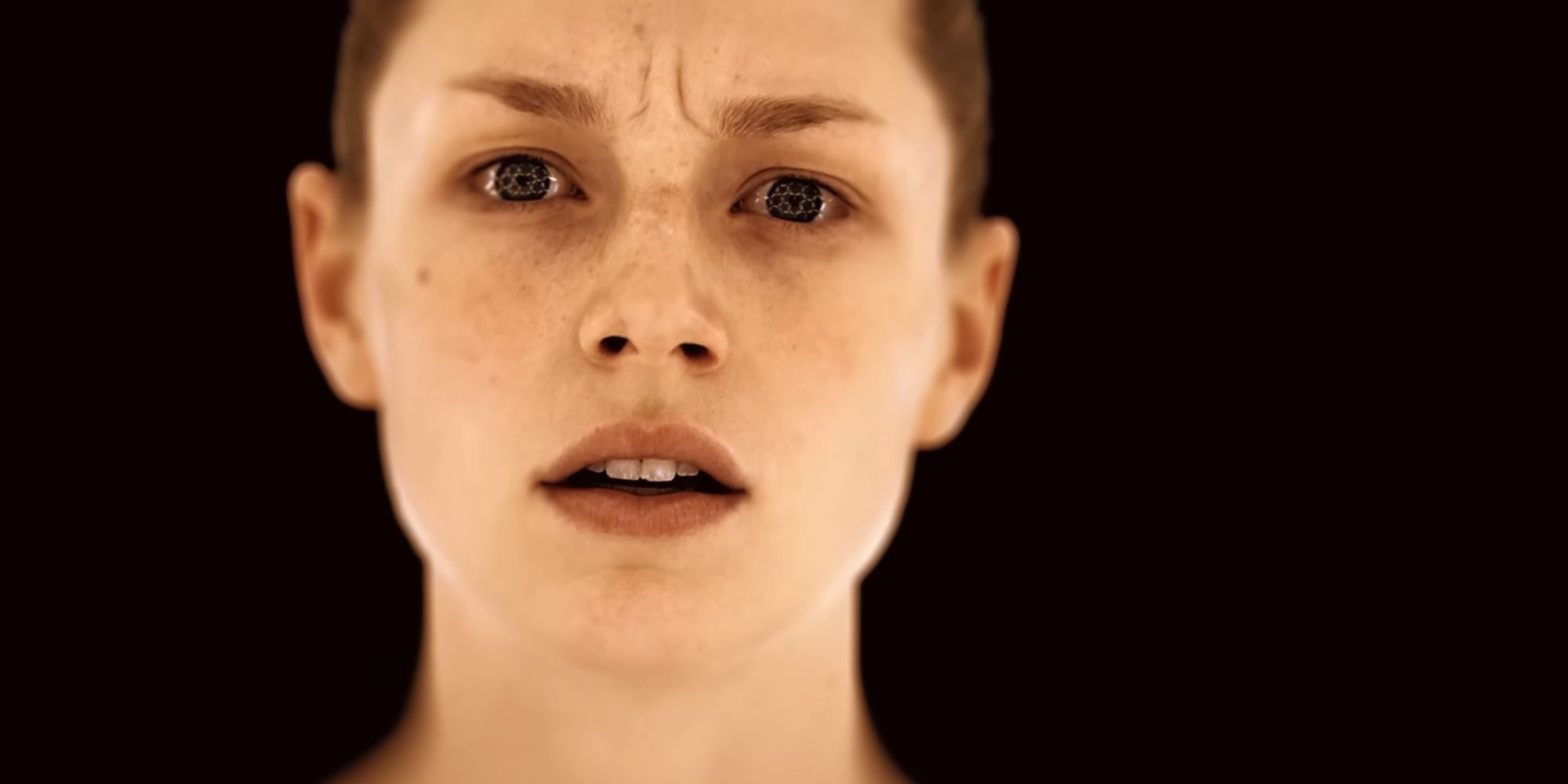 Close-up of Hunter Schafer's character amid a black background in the trailer for OD.