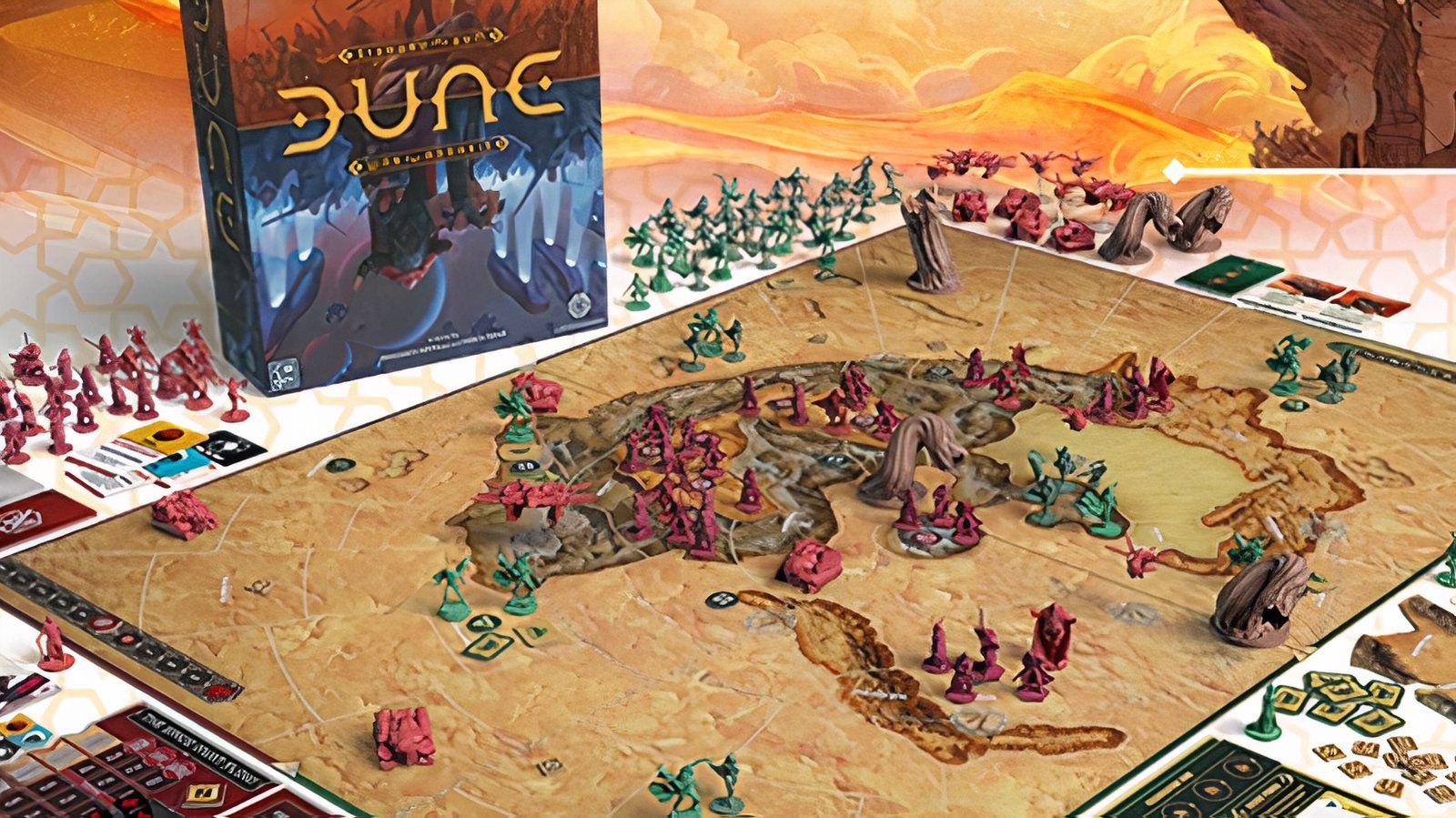 Dune: War for Arrakis board game setup, with figurines, cards, and game box in the background.