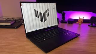 Asus TUF A14 gaming laptop on a wooden desk