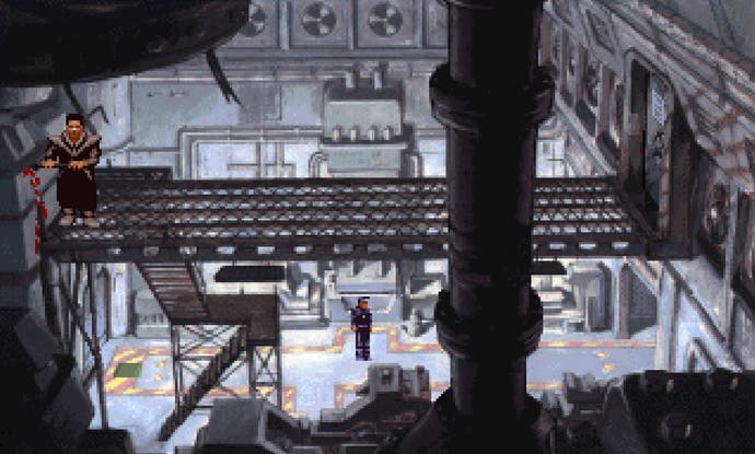 A man looks at a control panel inside a room with lots of discarded robot parts in Beneath a Steel Sky.