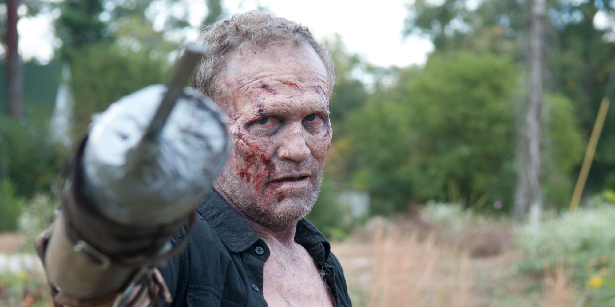 A bloodied Merle Dixon from The Walking Dead pointing at someone