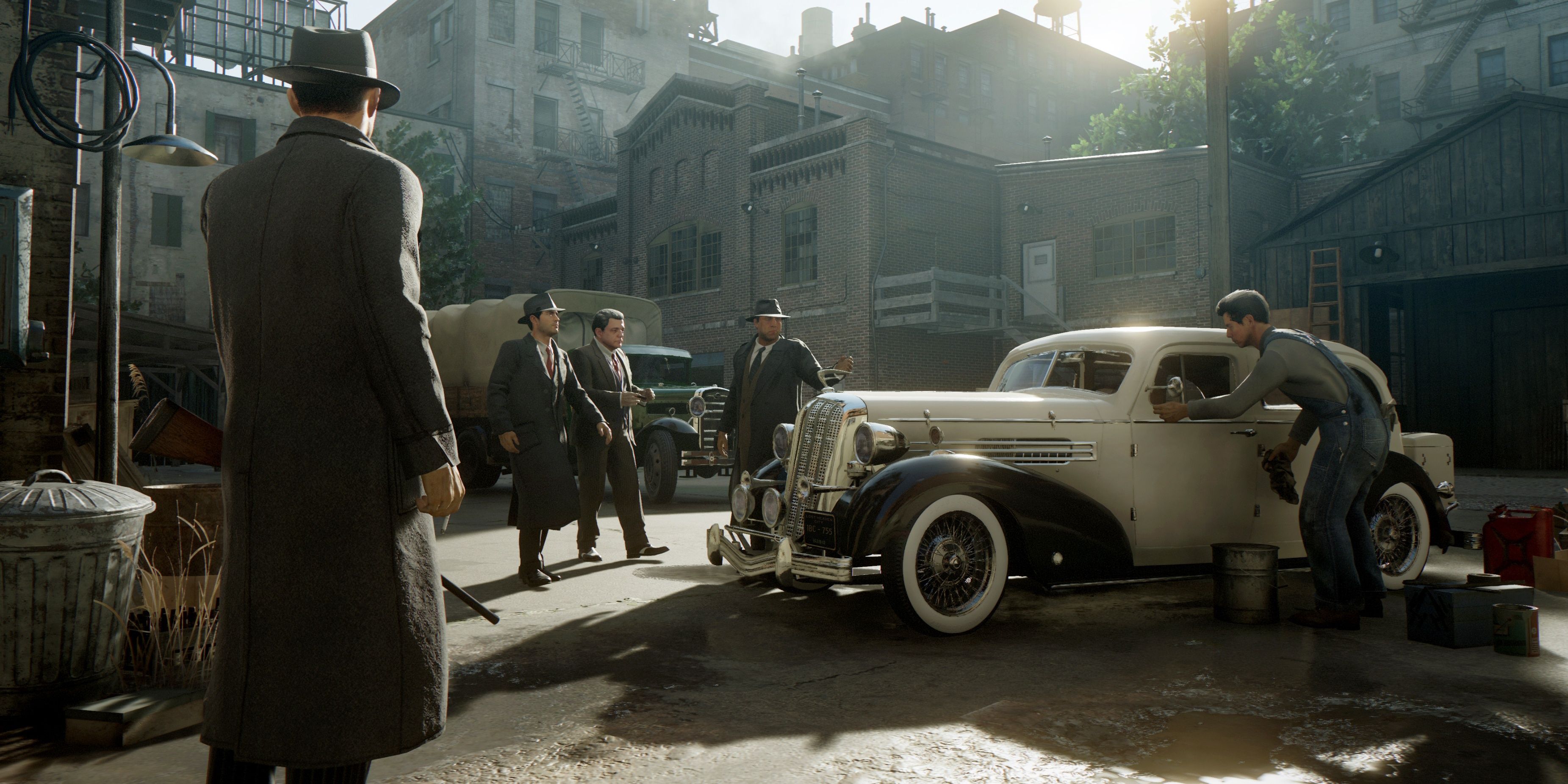 Mafia Definitive Edition screenshot of Tommy Angelo in lost heaven back alley next to car with other gangsters.