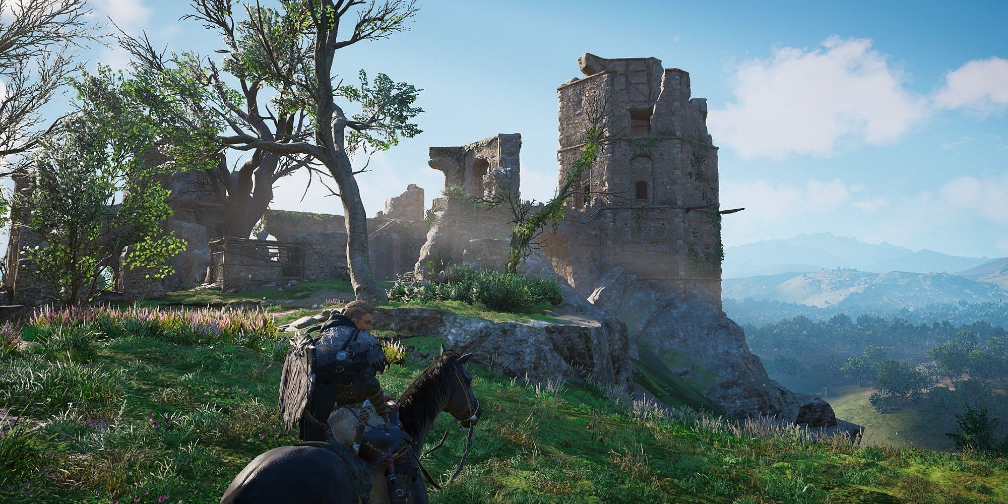 Eivor is on horseback, outside the ruins of a castle on a hill Assassin's Creed Valhalla.