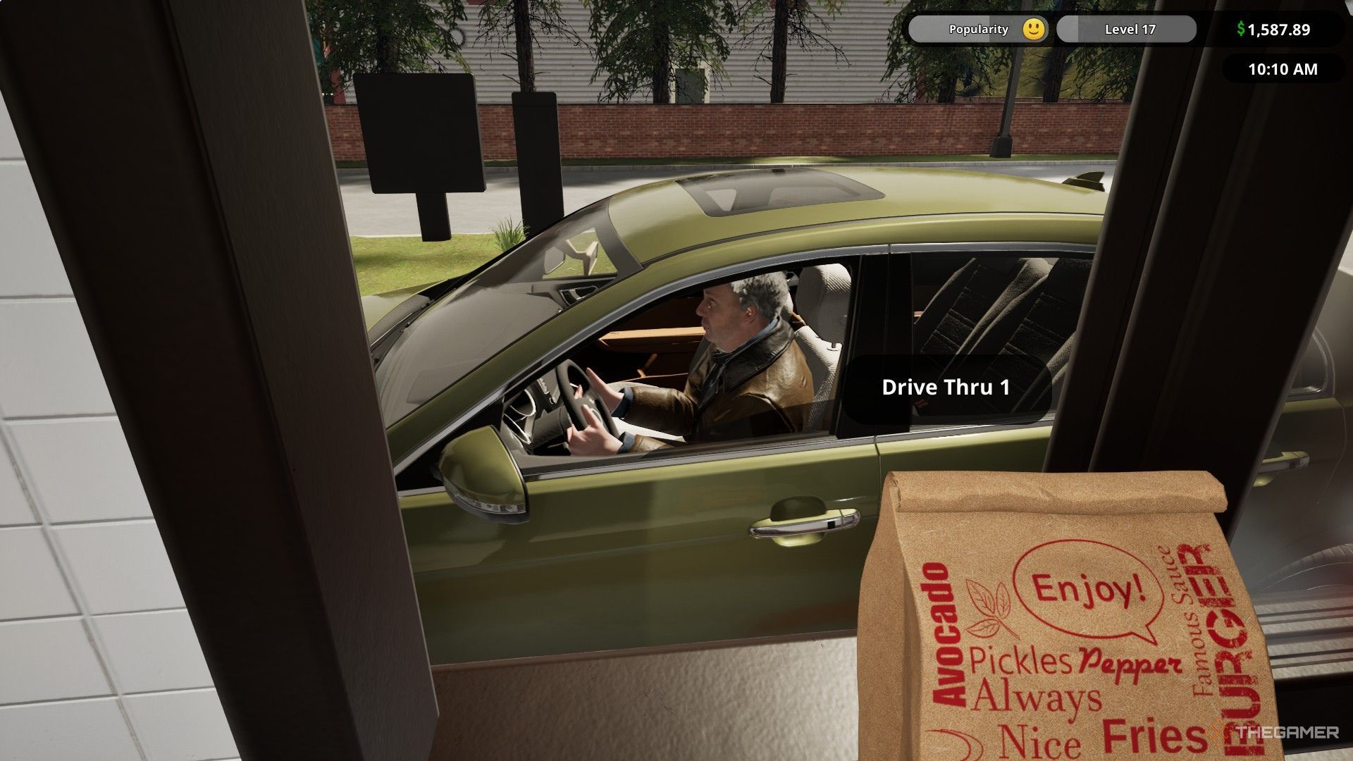 The image shows that the player is handing over a completed order to a customer through the drive-thru window in Fast Food Simulator.