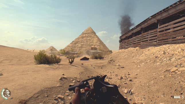 An screenshot shows the great pyramid in the distance and Indy reloading a revolver. 