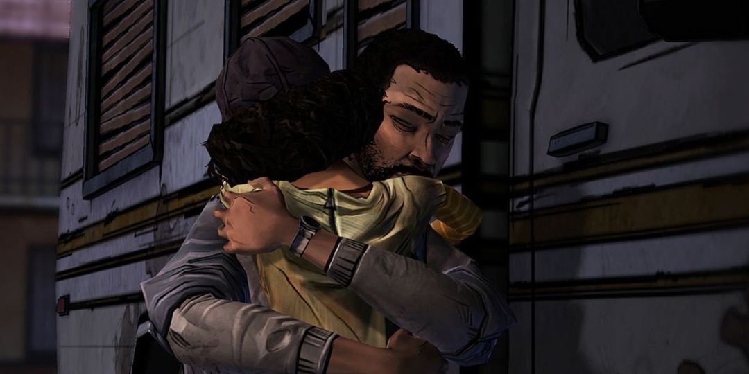 Lee embraces Clementine behind a deteriorated camper van.