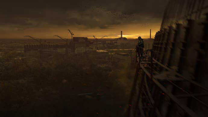 A lone Stalker can be seen looking off the edge of a tall structure and across the Zone in Stalker 2