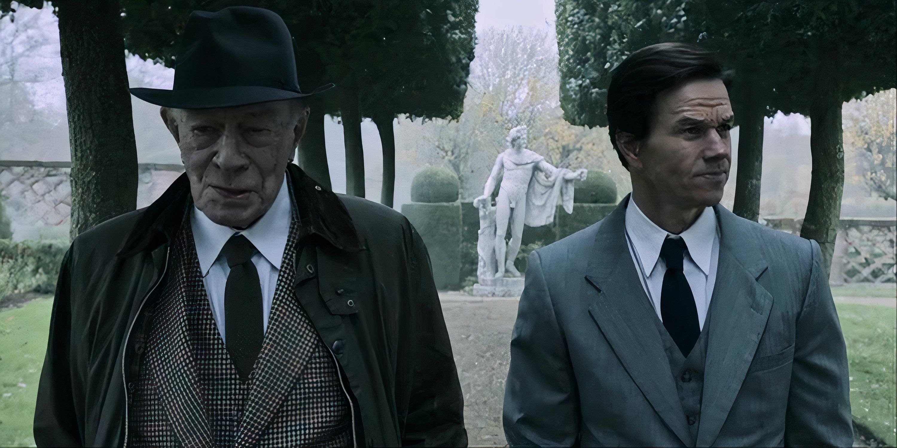 Christopher Plummer and Mark Wahlberg as their characters walking in a garden in All the Money in the World.