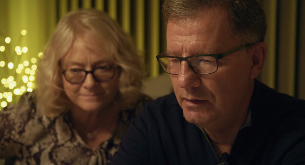 Close-up of two parents looking at a screen