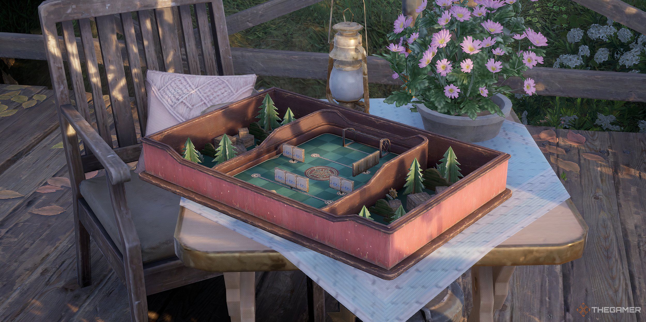 A Marble King box game sitting on a picnic-decorated table.