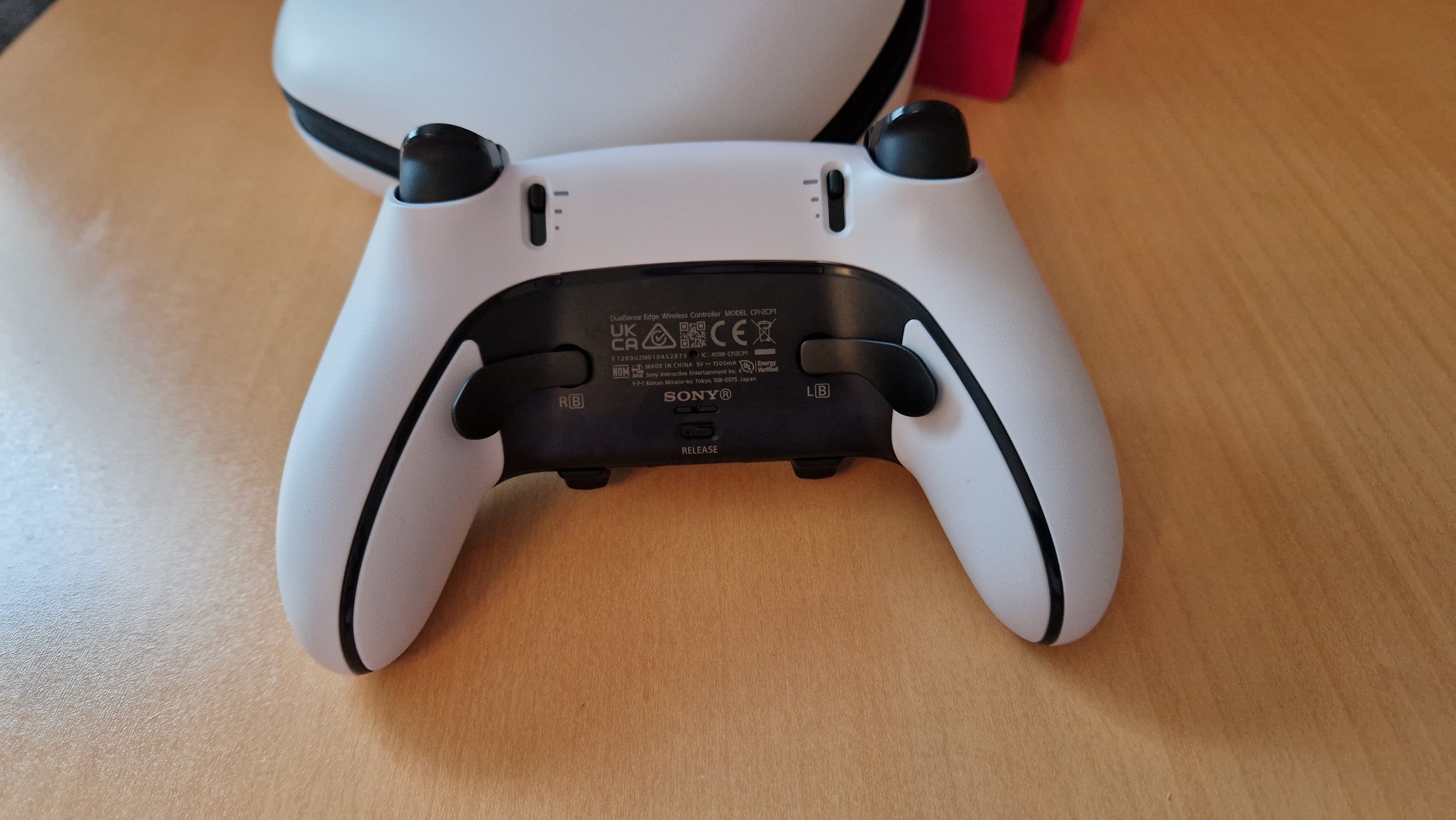 DualSense Edge review image showing the back of the controller and the longer paddle back buttons