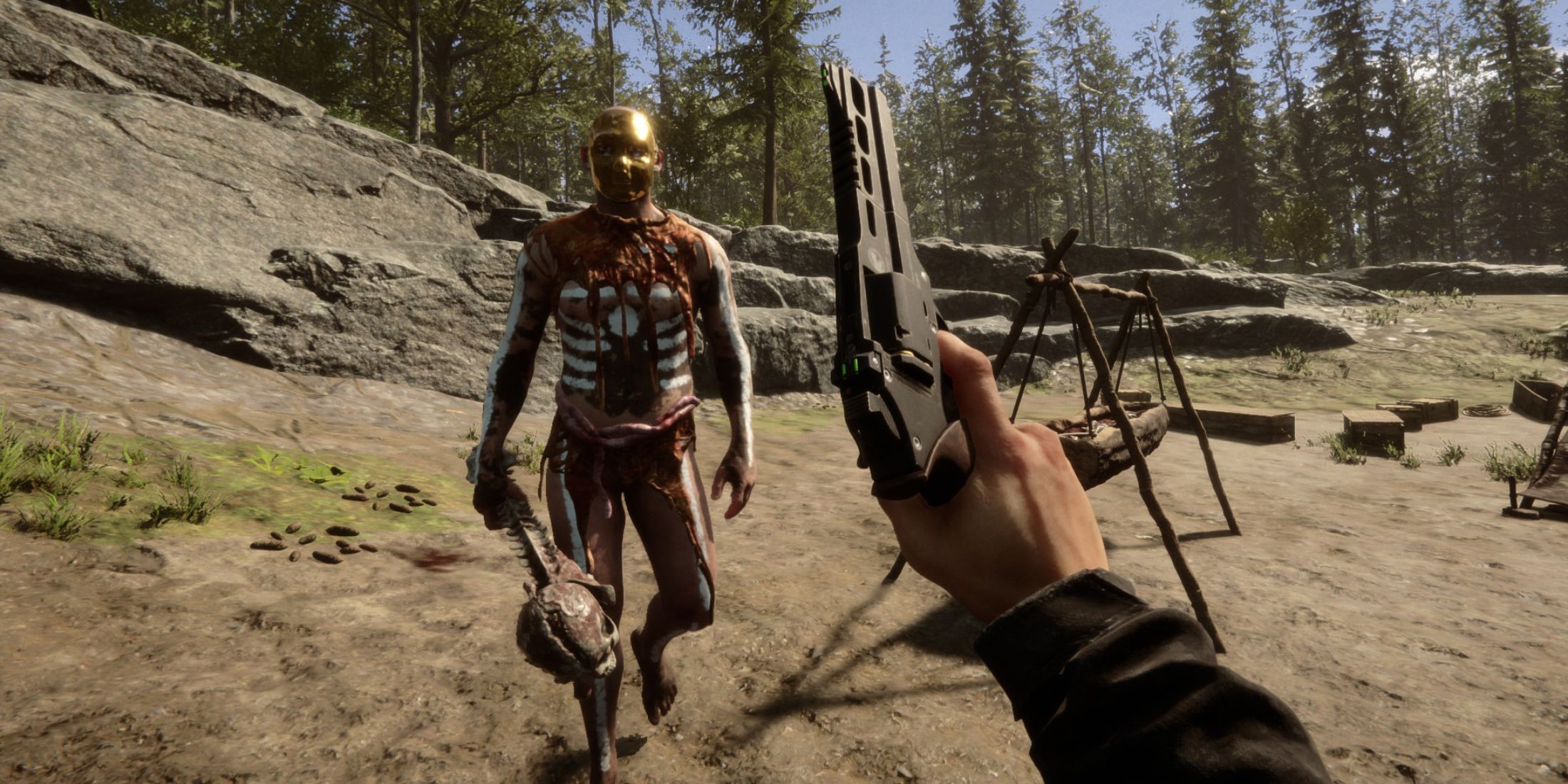 The player holding a gun up in front of an approaching Cannibal on the beach 