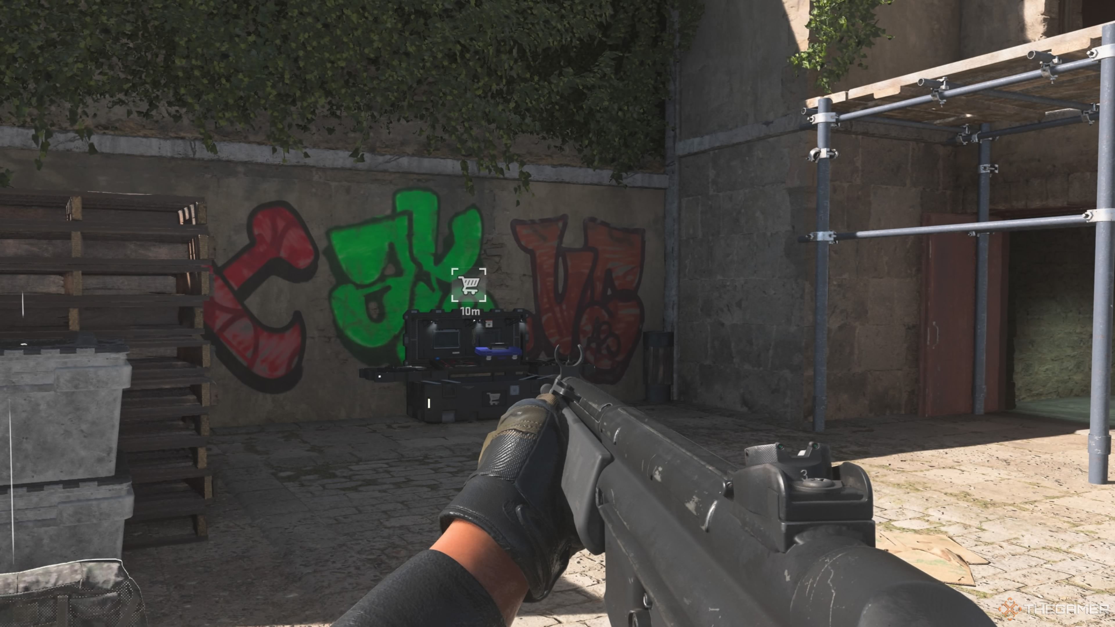 Image of a buy station in Call of Duty Warzone 2 DMZ with the icon indicating them (a shopping cart) visible on screen. The player is holding a rifle pointing towards the station against a wall. The back wall has colourful graffiti on it.