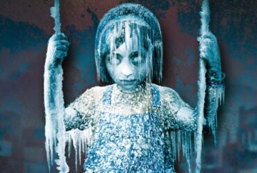 A frozen child sits on a swing in the key art for Silent Hill: Shattered Memories