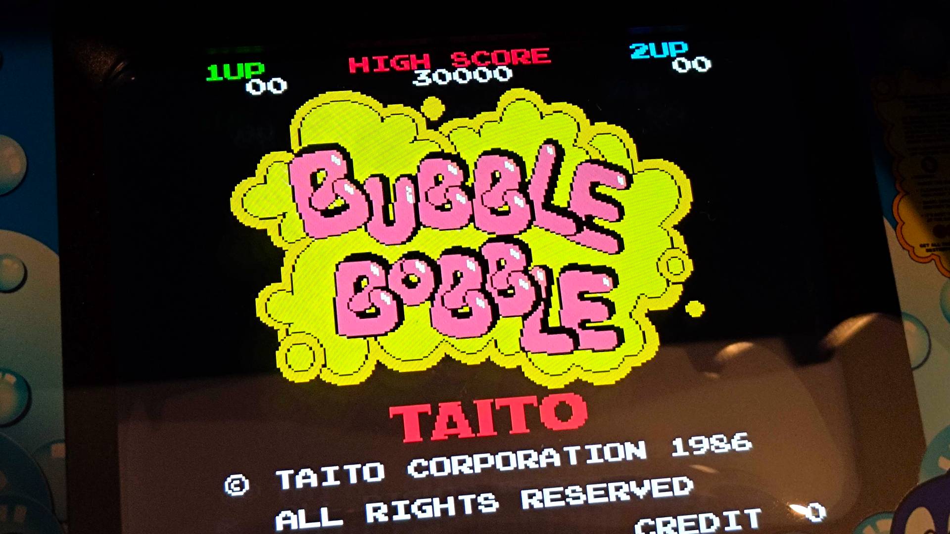 Close up of Quartercade Taito Bubble Bobble arcade machine with game title displayed