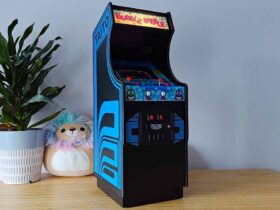 Quartercade Taito Bubble Bobble arcade machine with marquee illuminated sitting on woodgrain surface