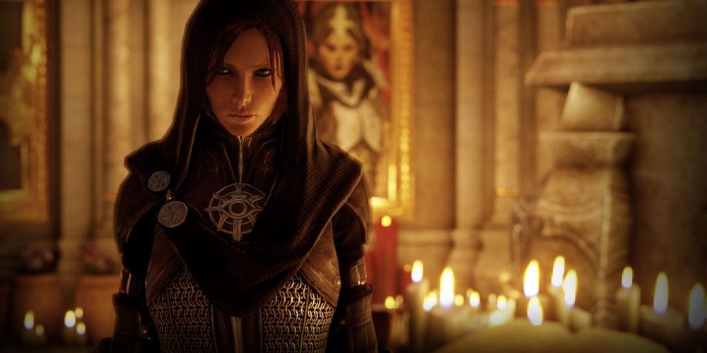 Dragon Age Inquisition Leliana in front of an altar littered with candles.