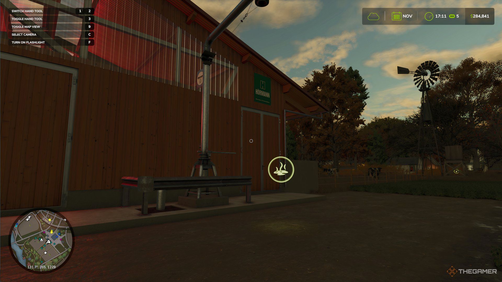 Floating dung icon next to cow barn in Farming Simulator 25.