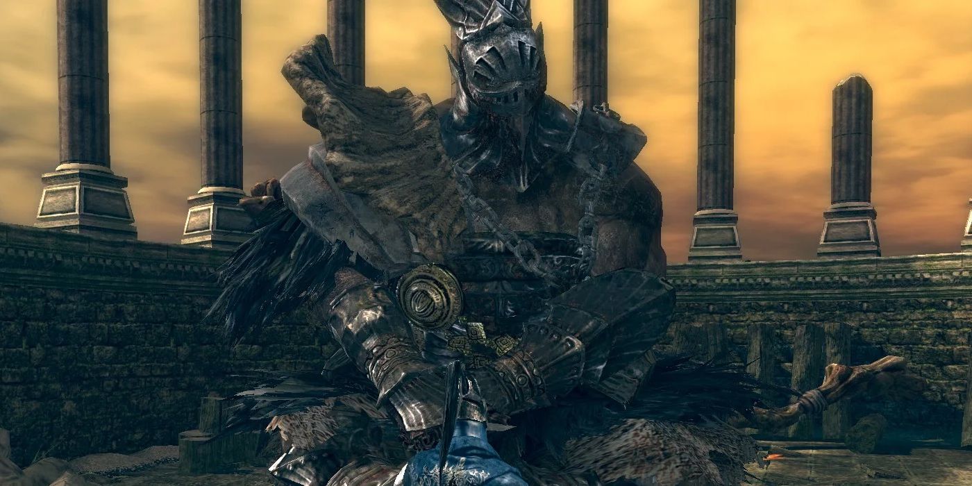 The player in front of a huge crouching warrior from Dark Souls.