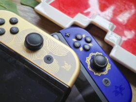 Photo of the OLED Tears of the Kingdom Switch sitting on top of the LCD Switch with the Skyward Sword HD Joy-Cons attached.