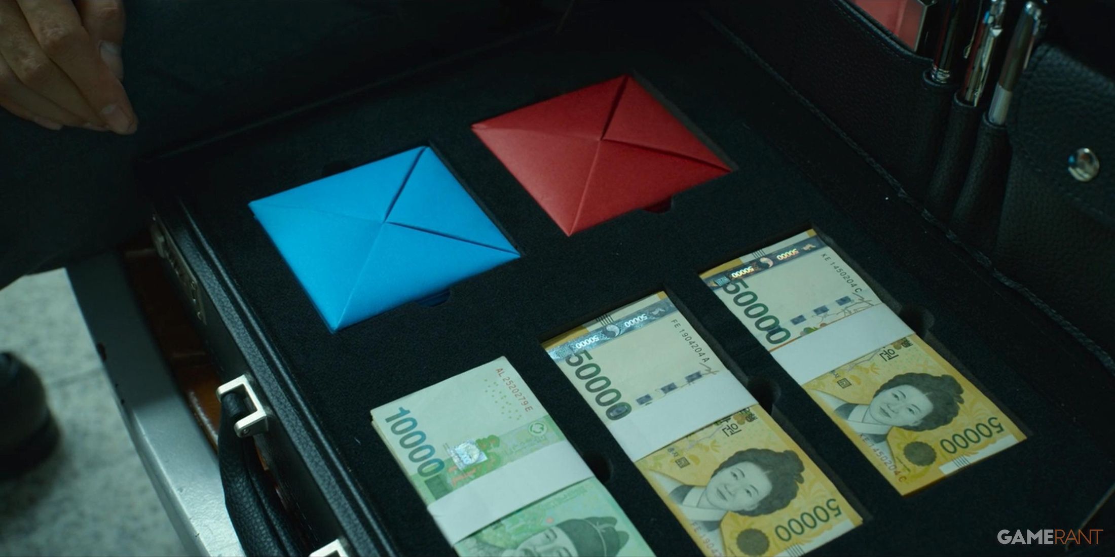 two card and money inside a metal case