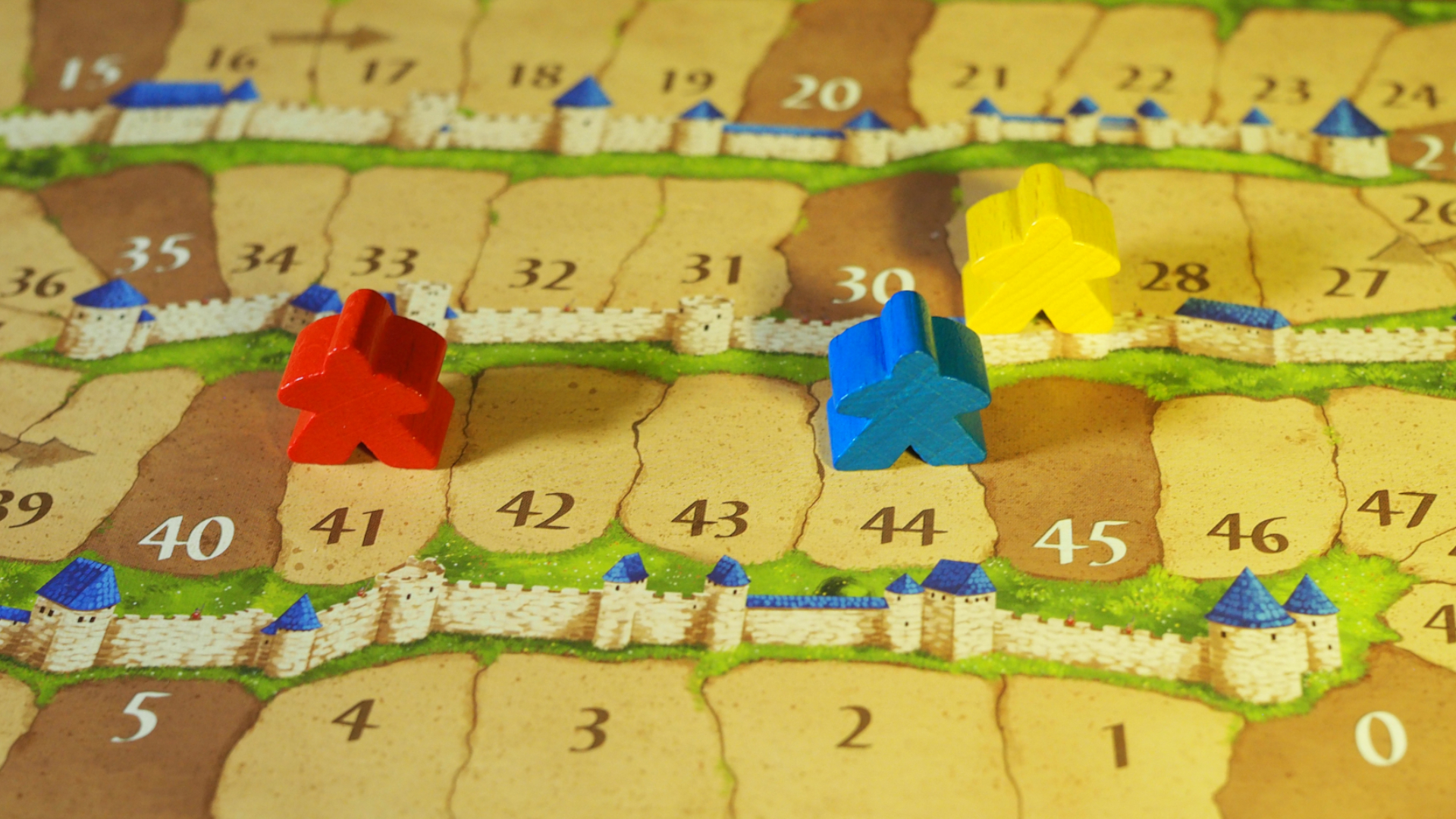 Meeples placed on the Carcassonne score board