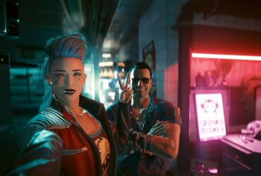 Cyberpunk 2077 screenshot of female V taking a selfie with Viktor Vektor in his cyberware shop