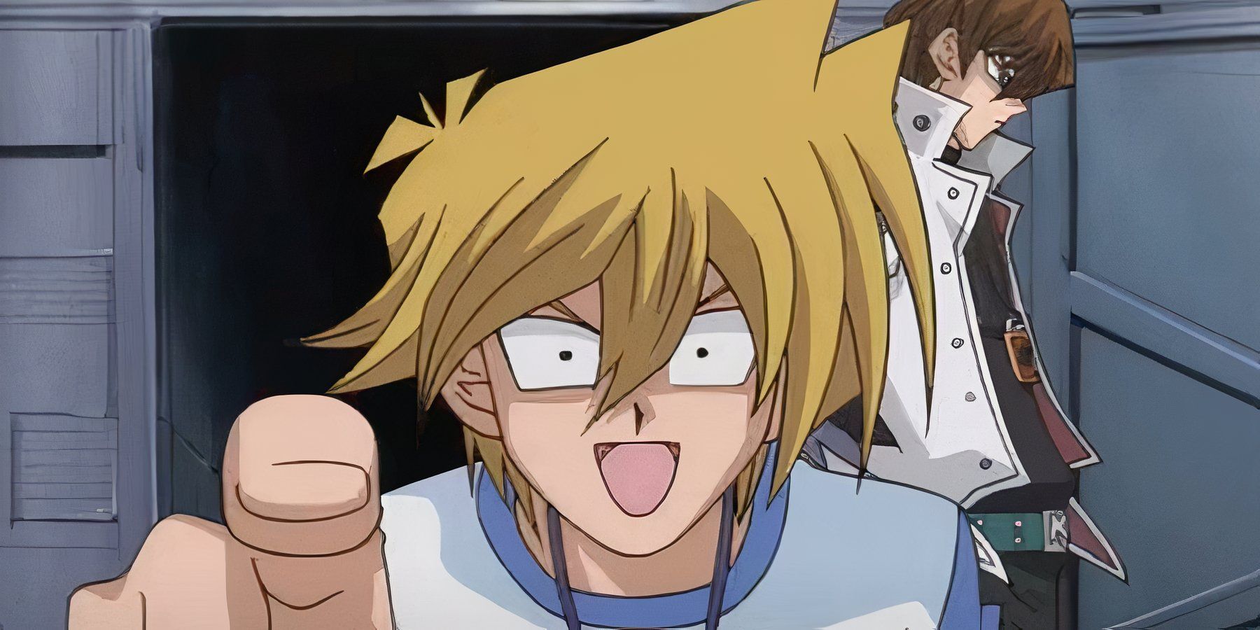 Joey pointing at the camera while Kaiba walks behind him 