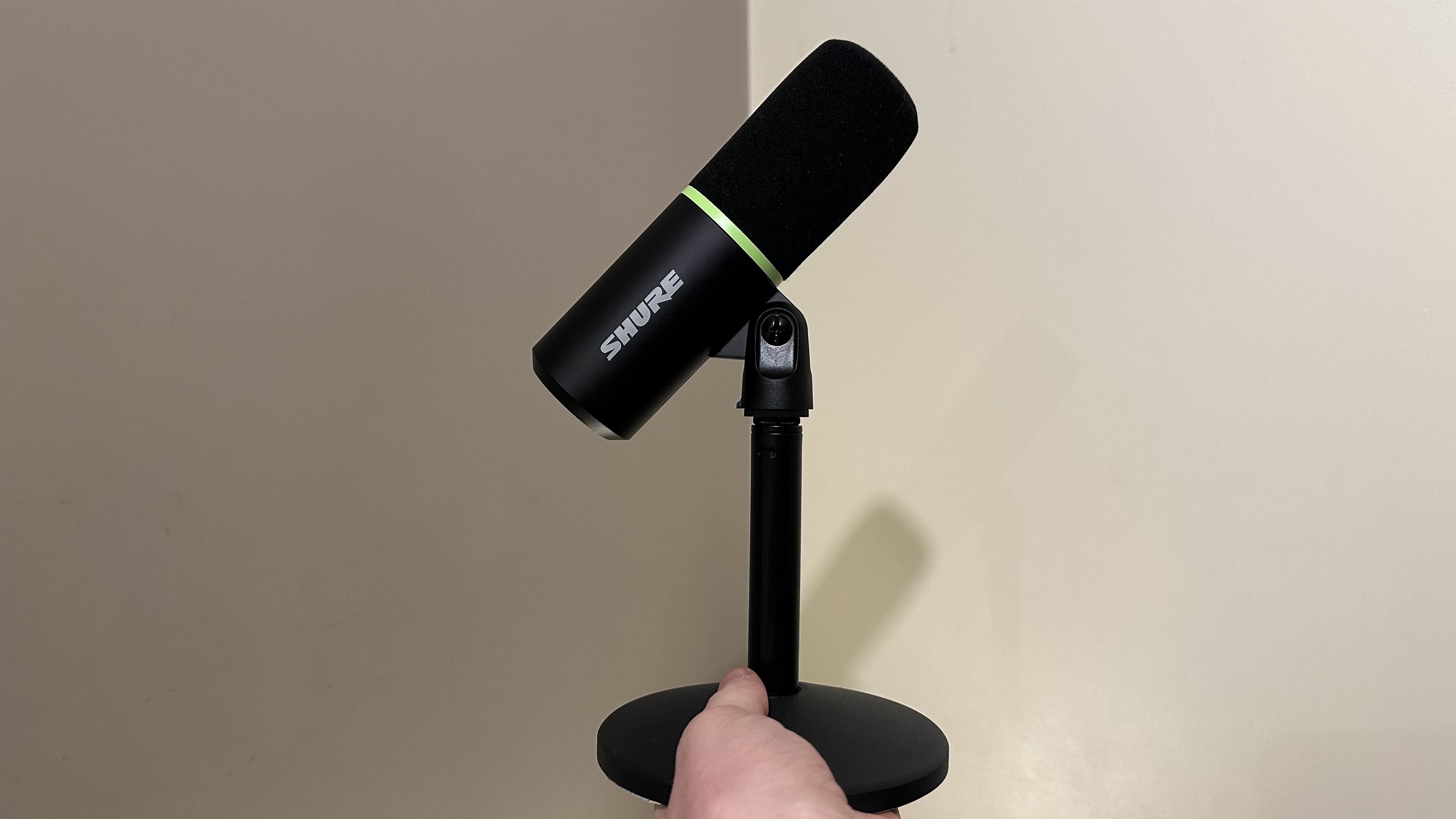 The Shure MV6 microphone being held by a reviewer