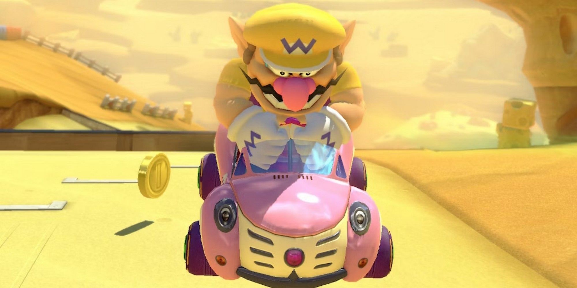 Wario in a pink kart in Mario Kart 8. 