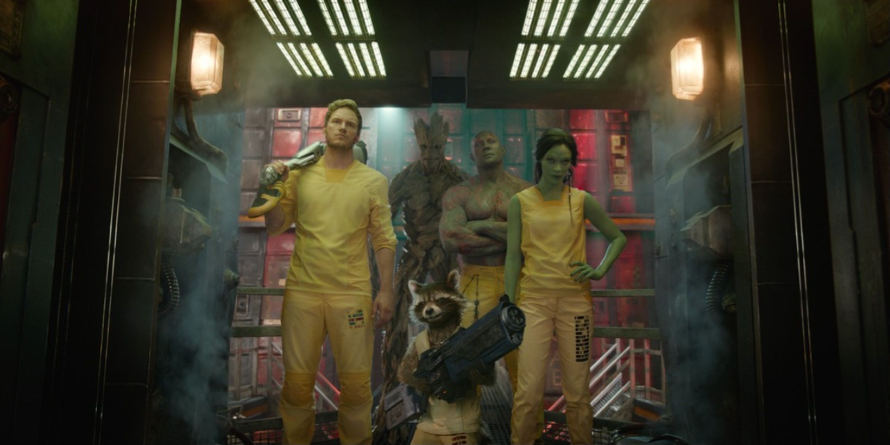 Star-Lord, Rocket Raccoon, Gamora, Groot, and Drax in yellow jumpsuits in the first Guardians of the Galaxy film.