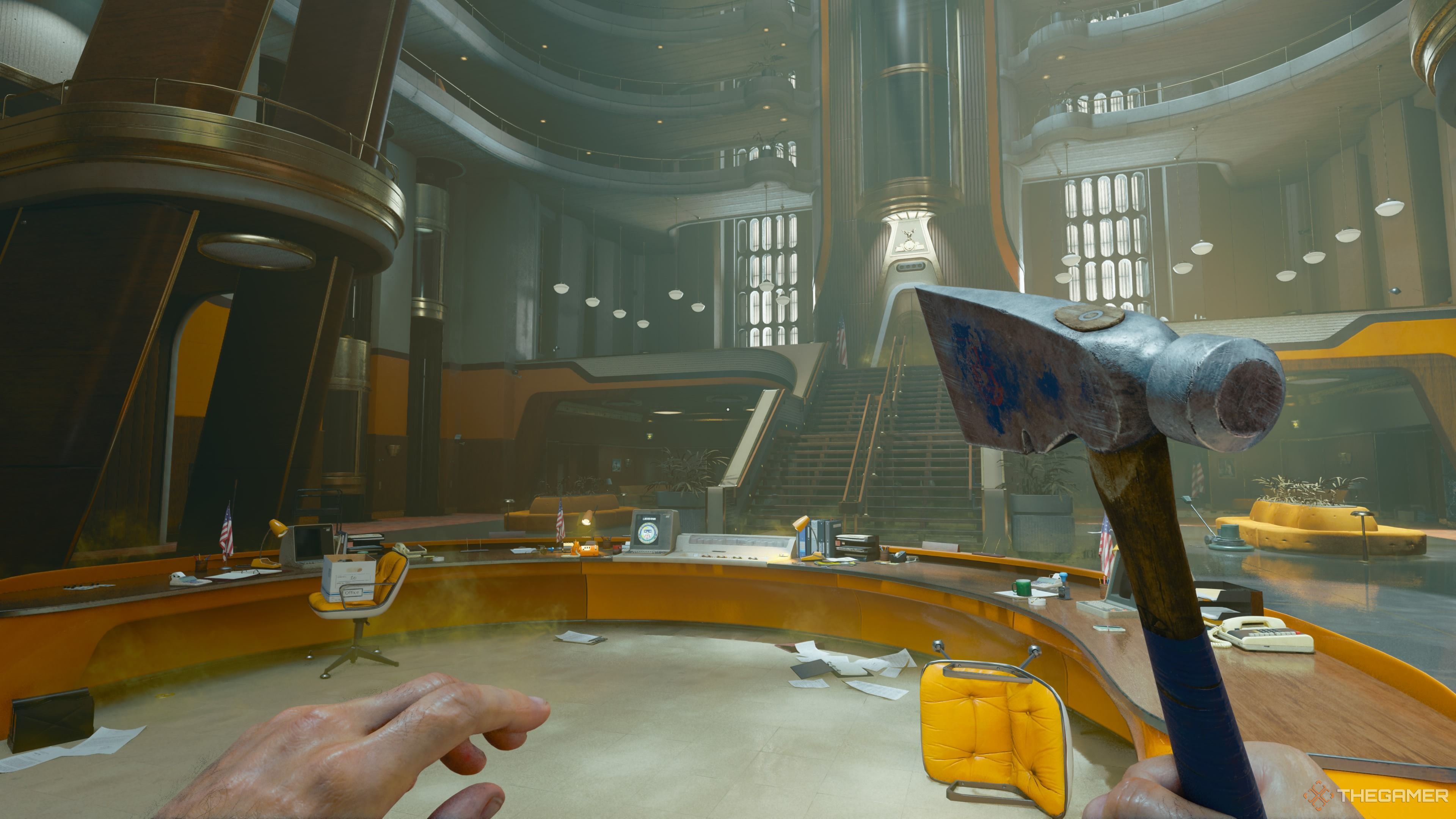 An image with the Central area of the Facility in Emergence shown. The player is carrying a hatchet and the desk is nearby with a terminal on it.