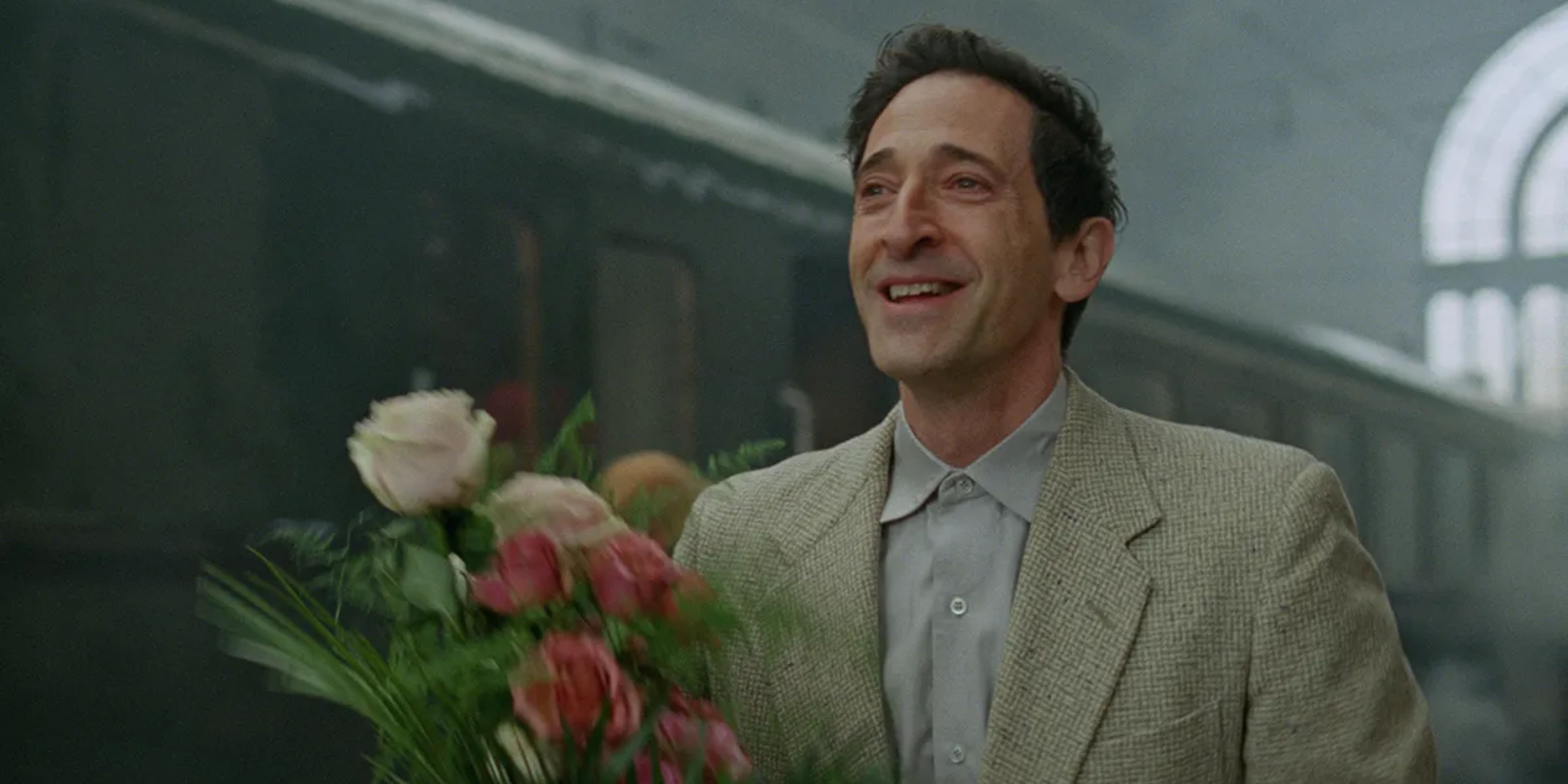 Adrien Brody with flowers in The Brutalist