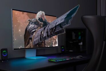 Samsung Odyssey 3D monitor on desk with The First Berzerker: Khazan graphics reaching out of screen