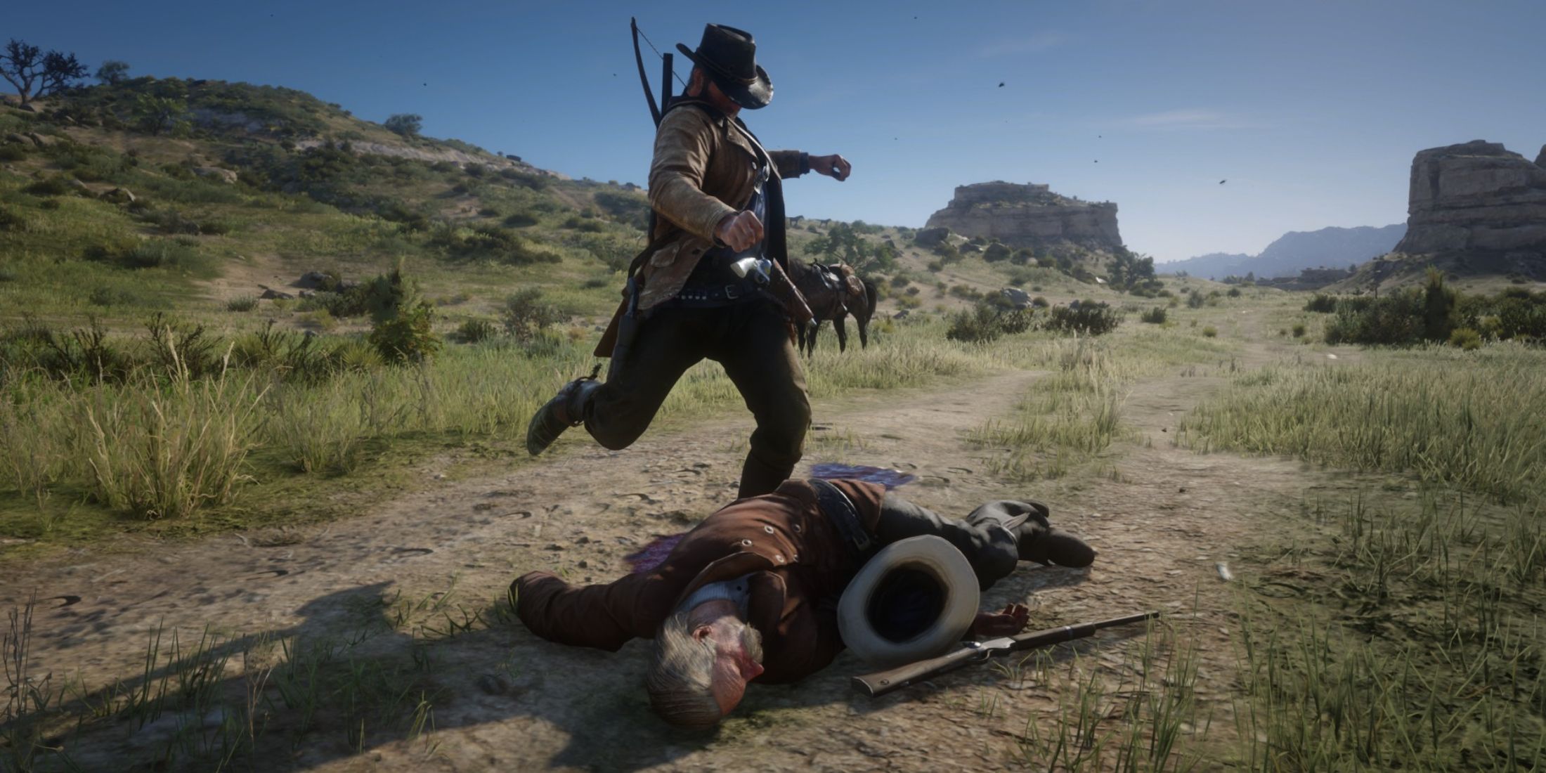 Arthur Morgan from Red Dead Redemption 2 kicking lawmen's body in Red Dead Redemption 2