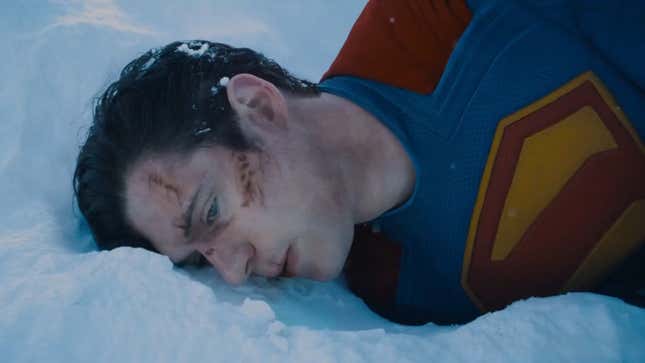 Superman, bruised and cut, lying in the snow.