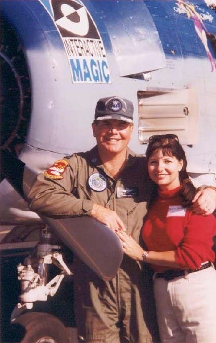 A photograph of Bill Stealey in Air Force uniform with his wife in front of an aeroplane.