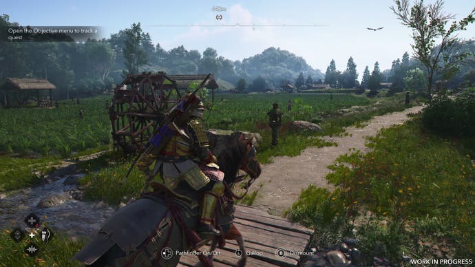 Yasuke rides past a rice field in summer time in Assassin's Creed Shadows. The plants are larger than they were in spring, obscuring the water.