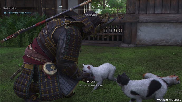 Yasuke pets a cat in Assassin's Creed Shadows.