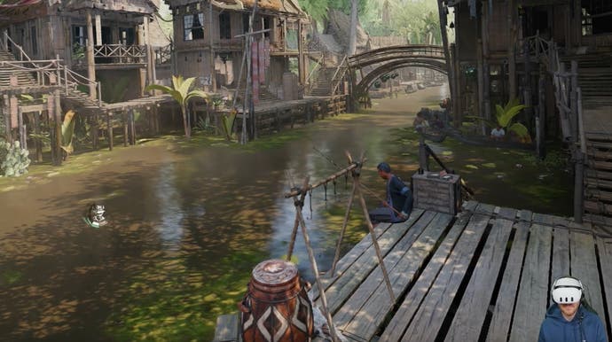 A river runs through an intricately built wooden village.